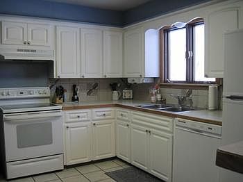 Nice, bright and fresh, what else can you ask for?  The kitchen in this home offers plenty of storage space with newer refaced white cabinets, newer appliances, ceramic back splash and flooring.  There is also enough room for the chef in your home to spread out and spend a day cooking!