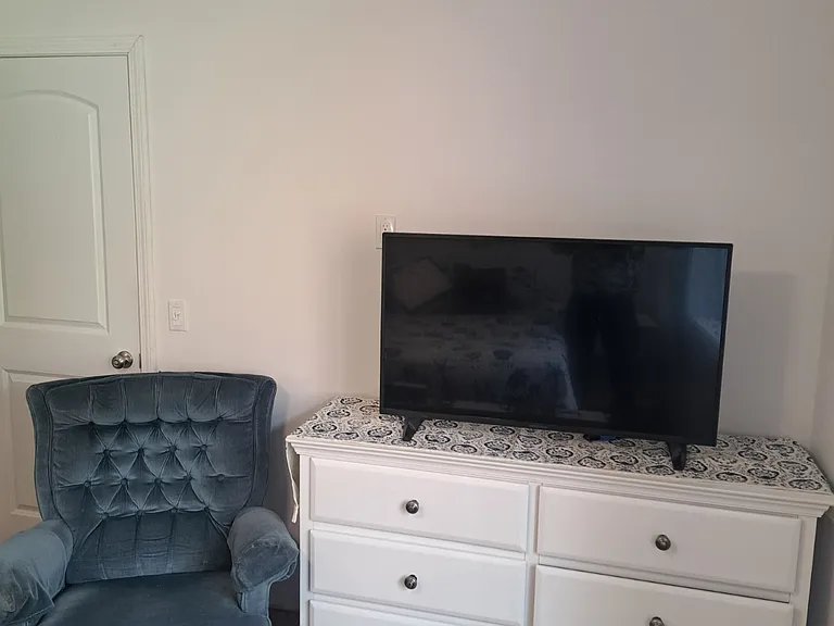 TV with Wi-Fi, Recliner Chair and Dresser in Large Bedroom