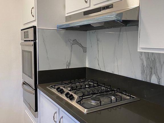 New cooktop and hood convenient to the new built in oven.