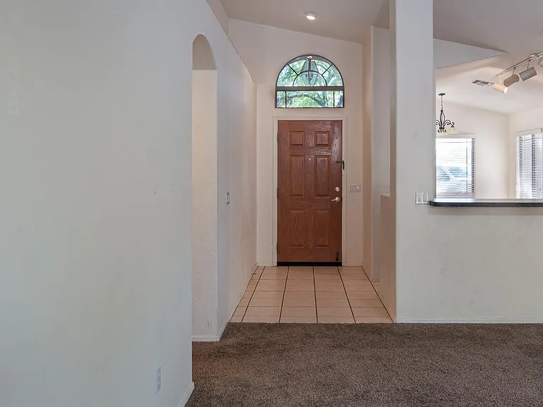 spacious living room with vaulted ceilings, open floor-plan, kitchen behind counter