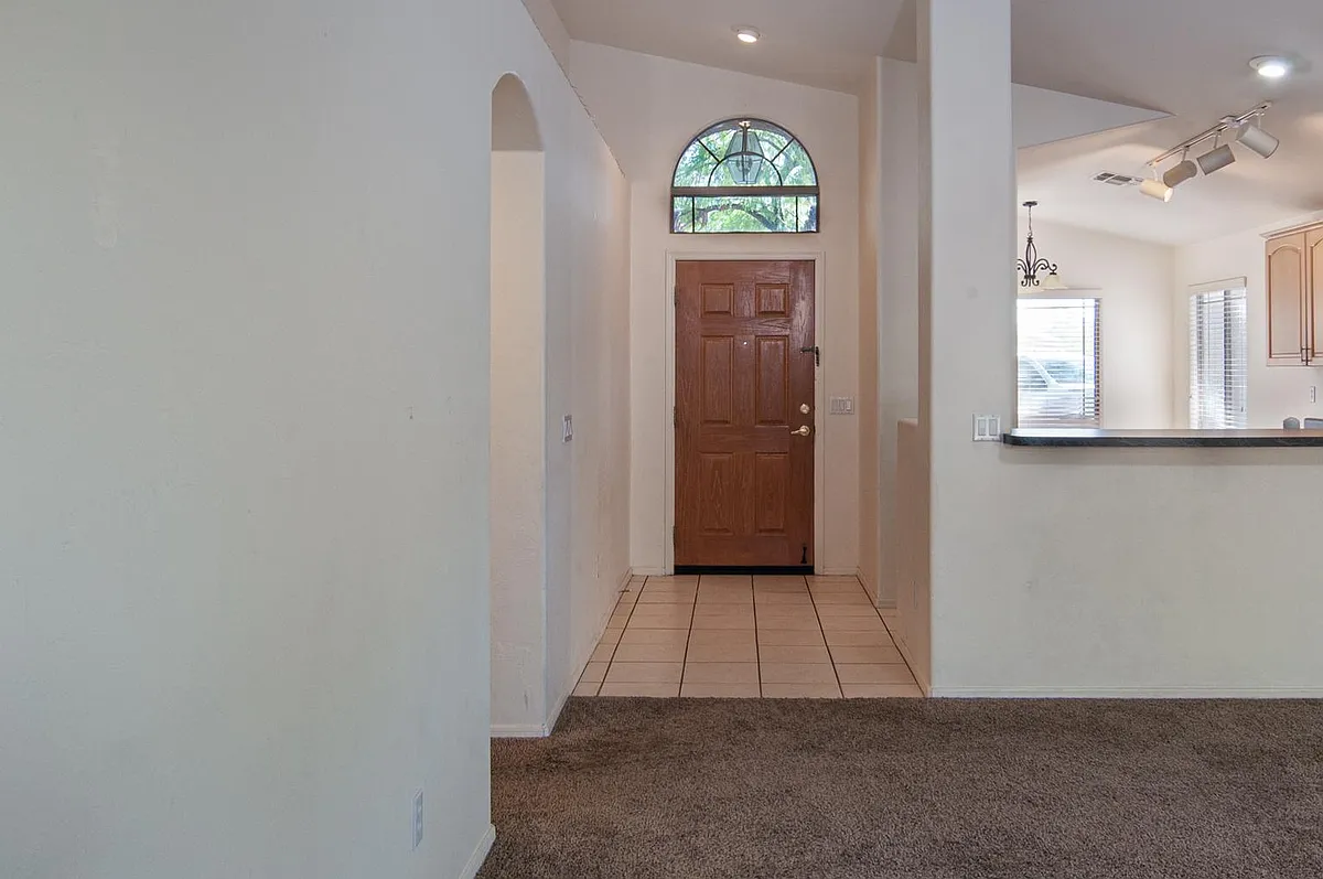 spacious living room with vaulted ceilings, open floor-plan, kitchen behind counter - 2171 N Deer Creek Pl