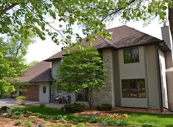 Outstanding private location with treetop views overlooking West Arm of Lake Minnetonka. You can see for miles! Enjoy fantastic sunsets! Beautiful perennial gardens surround the home.