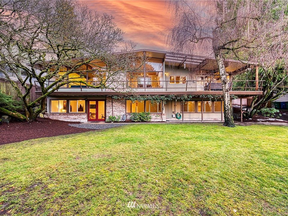 Home sets far off the street with a spacious level lawn. The entrance is on the back side of the house.