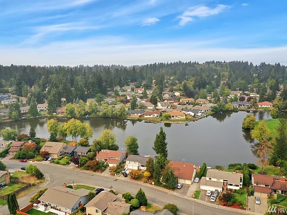 Light & Bright Living Room with Vaulted Ceiling and cozy wood burning stove.
