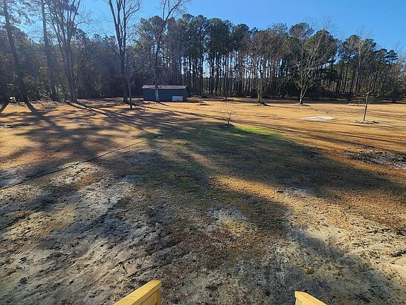 Rear exit providing easy access to the expansive backyard, perfect for outdoor entertaining and family activities.