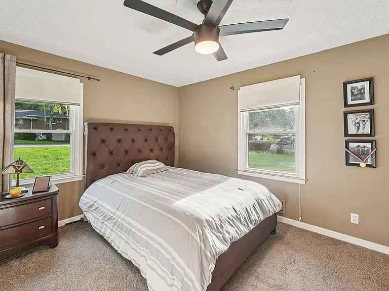 A peaceful bedroom retreat filled with soft natural light, plush carpeting, and warm neutral tones, creating a cozy haven for rest, reflection, and everyday comfort.