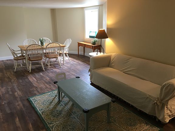 Living and dining room with sunny window overlooking the garden