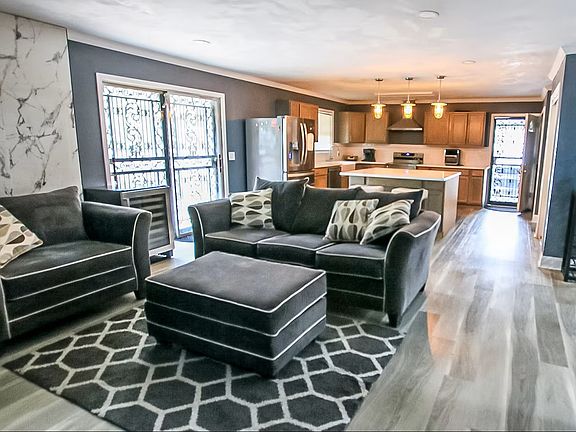 Another angle of the living room couch set with the kitchen behind it.