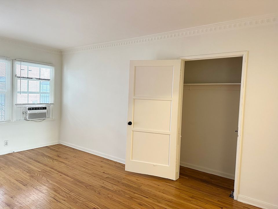 Living area with one of the closets. Original wood floors