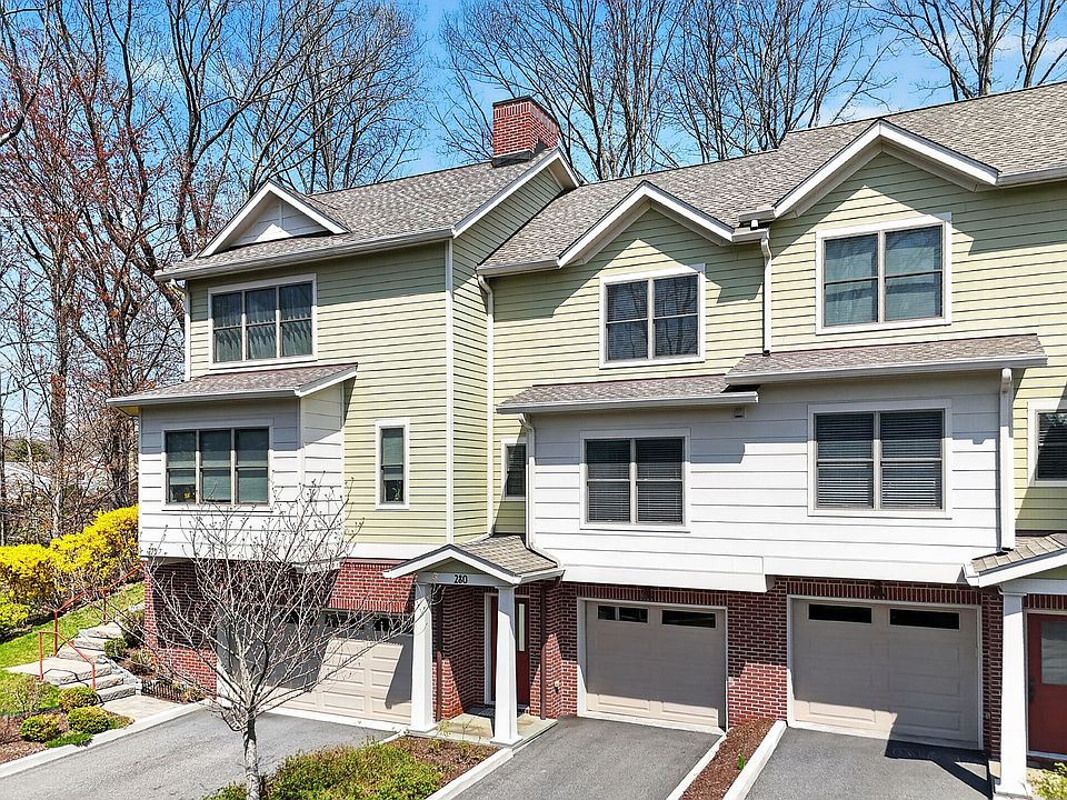 Front of building. Middle unit with one car attached garage.