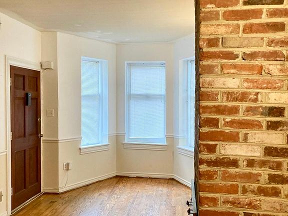bright living room with exposed brick