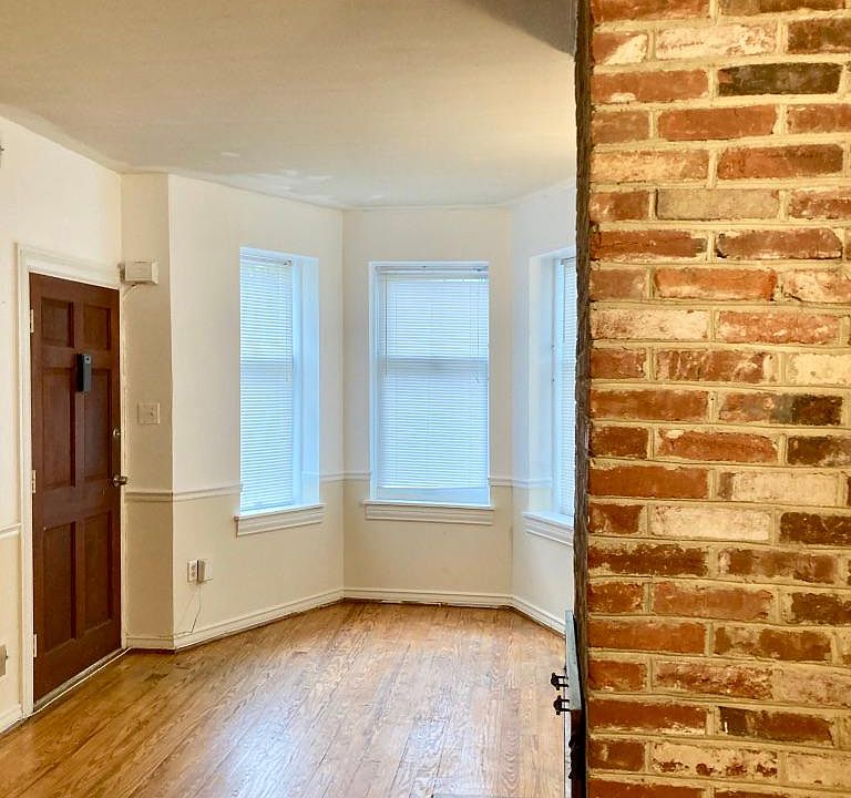 bright living room with exposed brick
