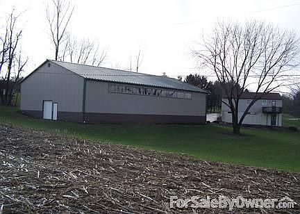 Side of storage building & back of house : Property line starts at edge of farm field.