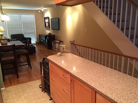 Standing in kitchen, looking across dining area into living