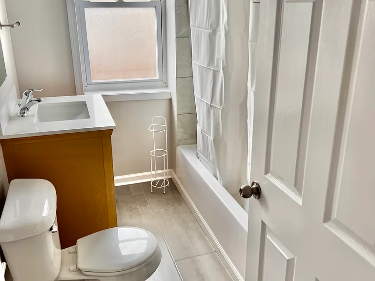 Bathroom with Ceramic flooring stand alone vanity.