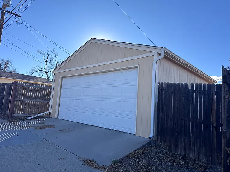 Alley access to detached, oversize two car garage. Can fit a Chevy Tahoe or similar.