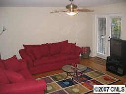 Spacious living area with hardwoods and exit to patio