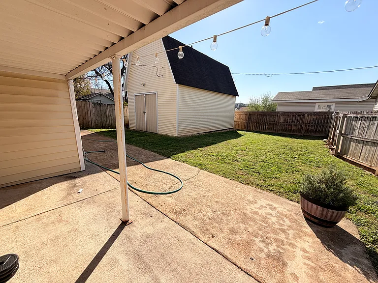 Spacious backyard with "barn" for storage. Covered back porch.