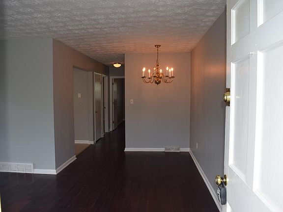 From front door looking toward dining area, kitchen and hallway. Family room is to the left.