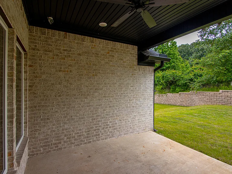 Covered back patio with outdoor ceiling fan, hook ups for wall mount tv