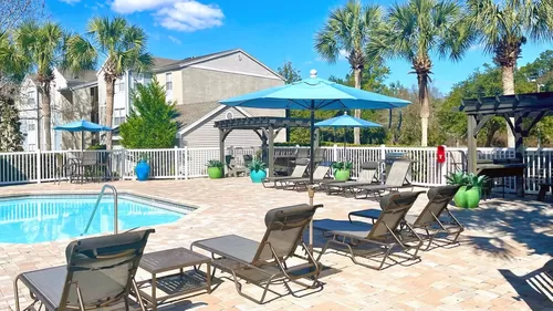 Discover poolside serenity on our spacious sundeck with abundant seating options under the sun. - The Enclave at Huntington Woods