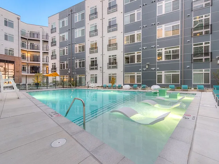 Courtyard with swimming pool, sundeck and lounge seating