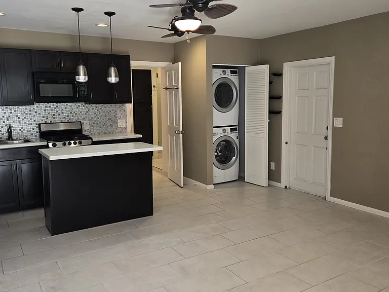 View of the Studio from the entrance showimg the Kitchen and Washer & Dryer