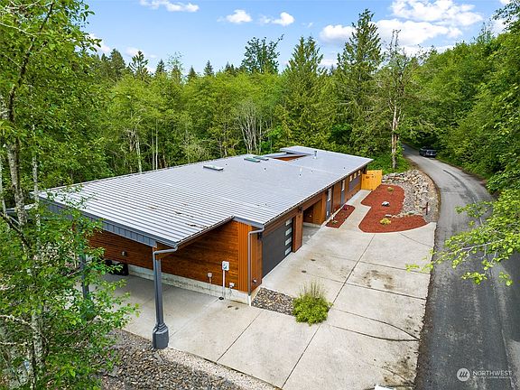Metal roof over a MASSIVE RV/boat bay next to a 4+ CAR garage.>