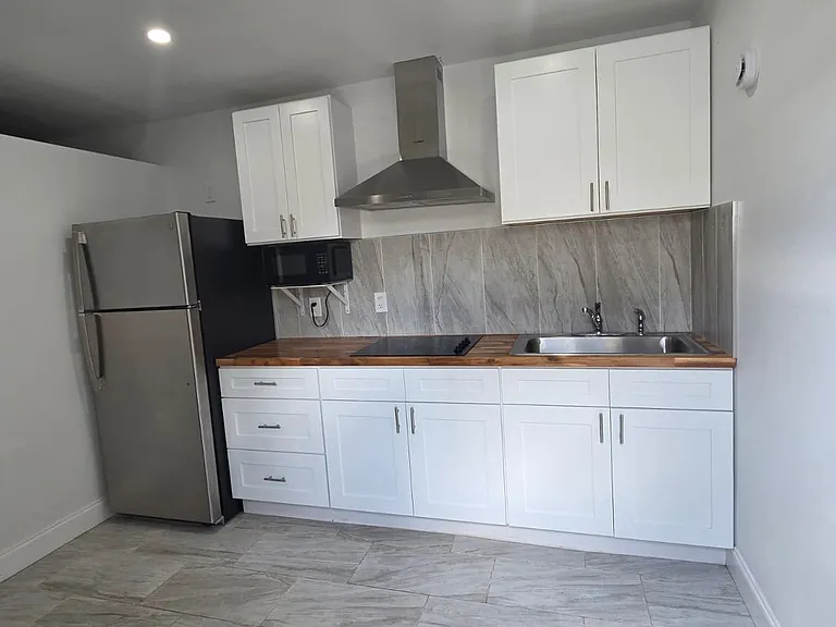 Fully equipped kitchen with refrigerator and microwave for your convenience.