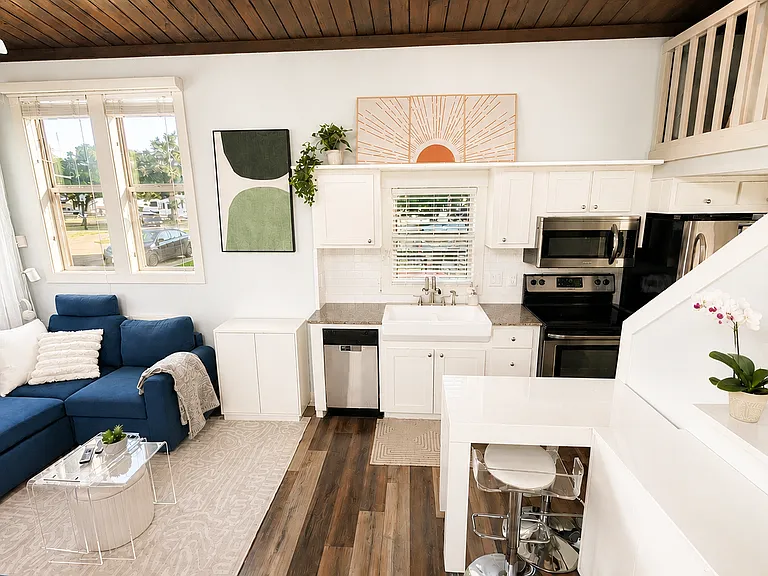 Cook at home with a full kitchen, dishwasher, and farmhouse sink.