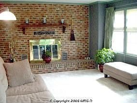 Large formal living room with lots of light