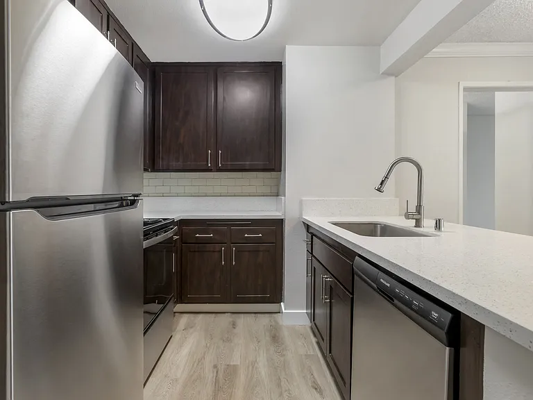 Modern elegance meets functionality in our remodeled kitchens, boasting sleek stainless steel appliances and pristine white countertops.