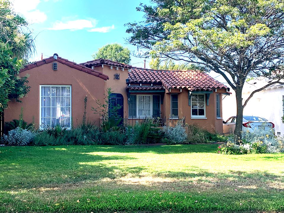 Unique Spanish style villa, beautiful curb appeal, adobe tiles, one of a kind.