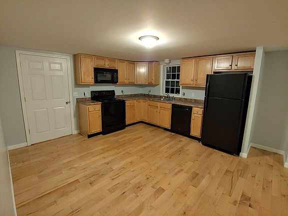 Black appliances have been replaced with stainless steel appliances.