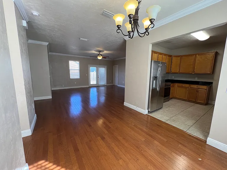 View of dining area, livingroom, kitchen Master bedroom door to right of French doors.