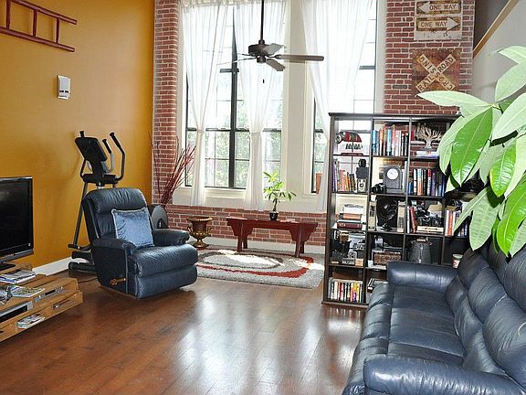 Oversized living room with huge windows providing lots of natural light