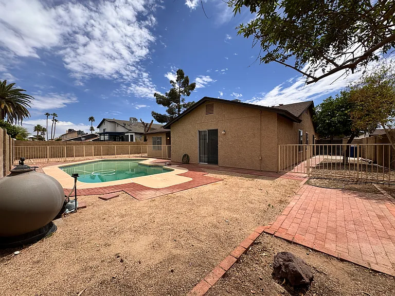 Backyard has fenced pool, fruit trees, RV gate with pad and lots of room for play