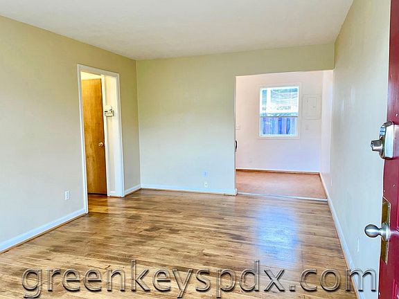Living room with view of dining room. Real wood floors!