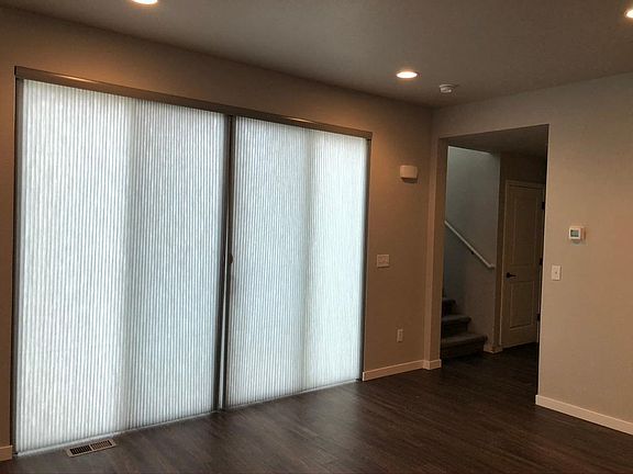 Custom blinds on the oversized patio doors, you get great natural light in this house.