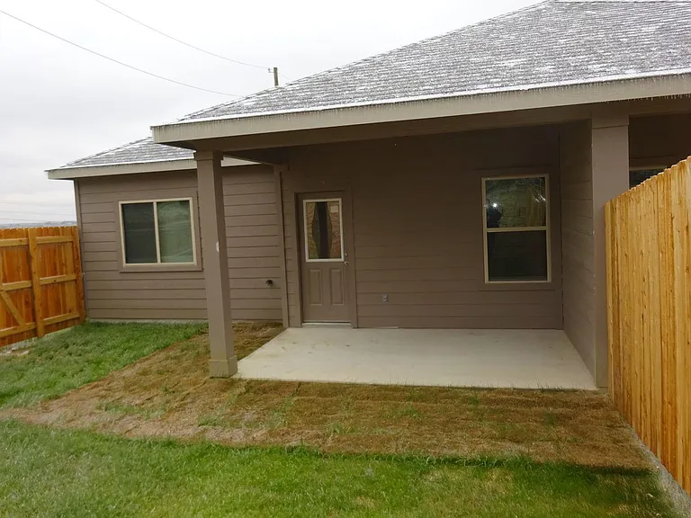 Private backyard with walkout porch from Primary bedroom