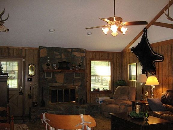 Soaring vaulted ceilings in living area with cozy wood burning fireplace. All overlooking Lake Winds
