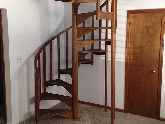 Spiral staircase leads to private second floor bedroom & bat