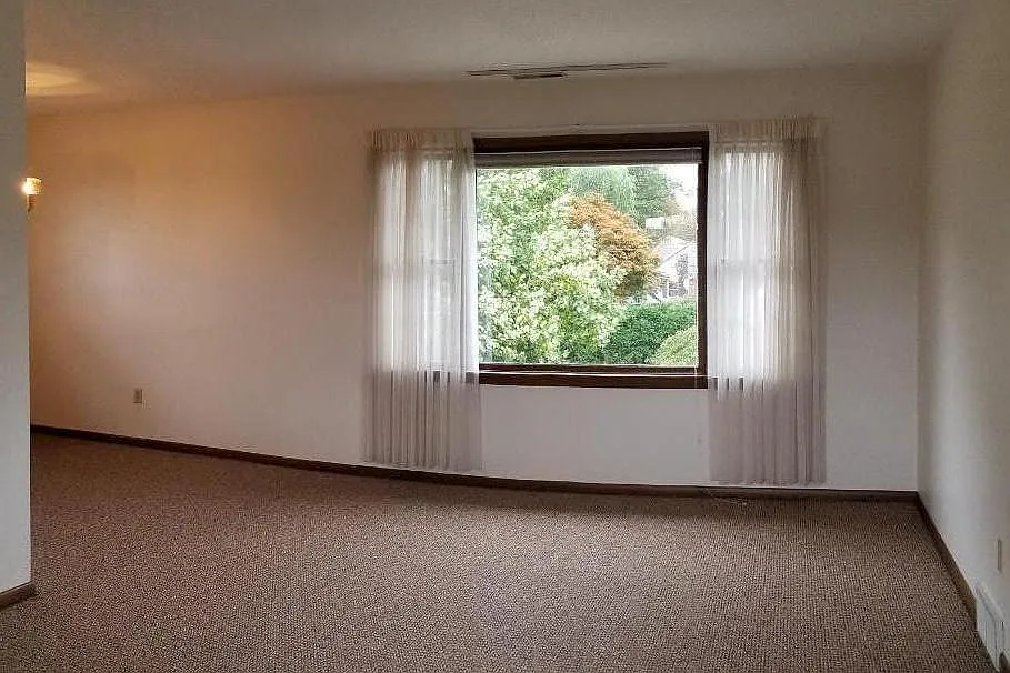 Enjoy the natural light and greenery pouring in from the large bay window.