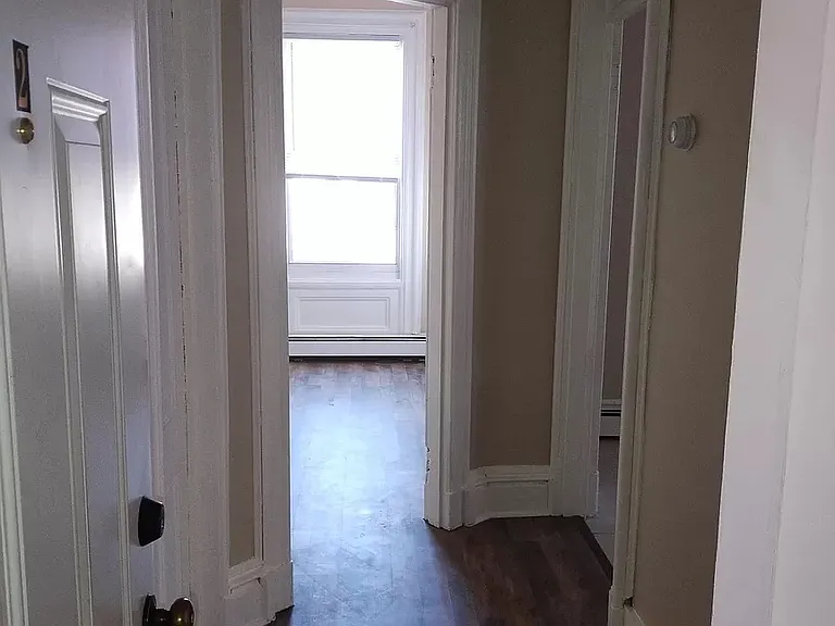 Entry to apartment. Spare room straight ahead. Kitchen top right doorway. Entry to living room bottom right doorway.

Second bedroom and bathroom are to the left, down another hallway.