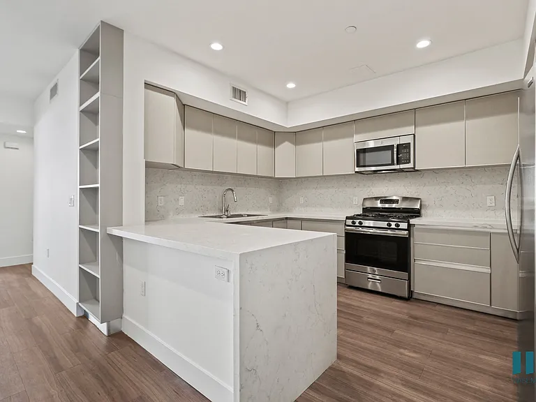 Open-Concept Kitchen with Energy-Efficient Appliances and Ample Cabinet Storage
