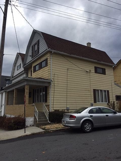 covered front porch, off street parking behind house