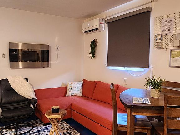 sofa bed with kitchen table. wall mounted electric fireplace .