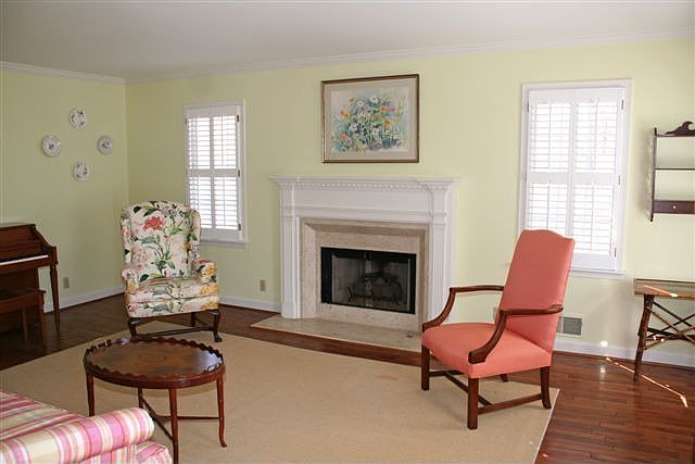Bright Living Room with Fireplace and Plantation Shutters
