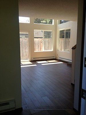 light filled open living room with new flooring. brand new energy efficient windows throughout