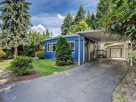 Carport and one of the two outdoor storage sheds. Side door from carport leads to kitchen. 